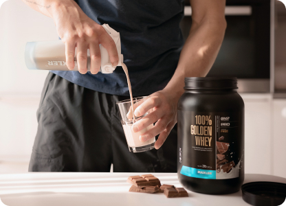 A photo of a man pouring 100% Golden Whey.