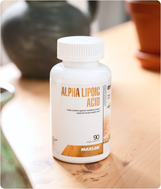 A photo of bottle of Alpha Lipoic Acid capsules on a table.