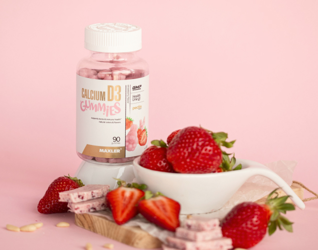 A photo of Calcium D3 bottle surrounded by strawberries.