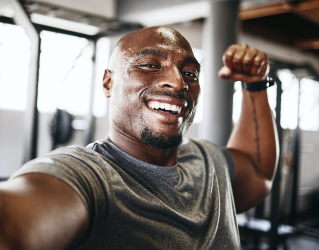 A photo of a smiling man in a gym.