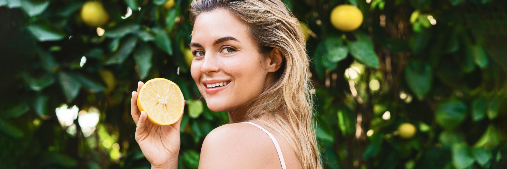 A photo of a woman with a lemon.